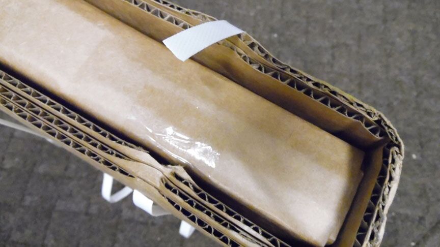 There is an inner rolled piece of cardboard<br />inside the outer protective piece.