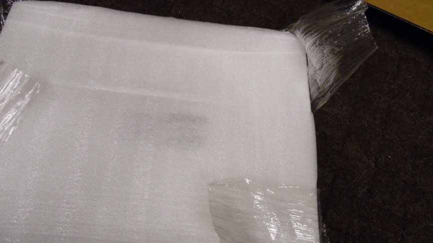 Pull up on the shrink wrap and cut it with<br />the blade edge toward you. DO NOT cut<br />down on it, you might hit the door.