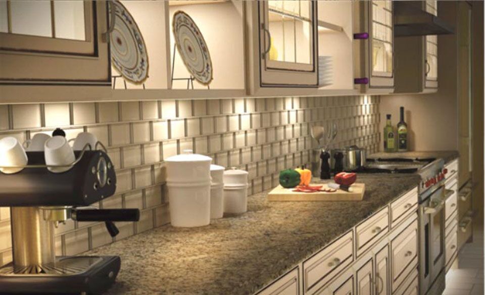 This is a warm looking kitchen. A soft glow along the counters and on the inside of the upper cabinets. Some of the uppers have glass mullio
